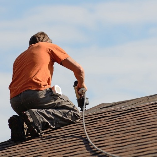 A Roofer Installs Asphalt Shingles